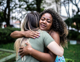 Two women hugging.